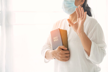 Religious woman in protective face mask