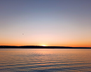 setting sun on the shore, waves on the sea