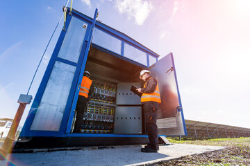 Checking the operating voltage levels of the solar panel switchgear compartment