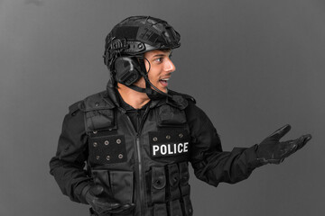 SWAT caucasian man isolated on grey background with surprise facial expression