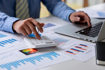Business man hand hold documents with financial statistic stock photo,discussion and analysis data the charts and graphs.Market research reports Accounting Finance concept
