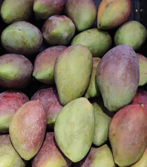 Bunch Of asian freshness organic sweet rare Mangoes on department store shelf, advertising backgrounds