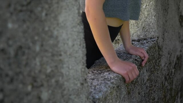 person climbing on a stone wall