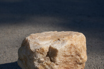 The concept of a summer layout for a product presentation. The platform is made of beige stone on the asphalt. High quality photo