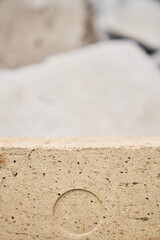 3D background with a stone podium display. Natural rock pedestal of beige color, on a stone background. High quality photo
