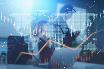 Businesswoman is taking notes on workplace and walking businessman on background. Laptop on desk. Office background, hologram Forex financial charts and world map.