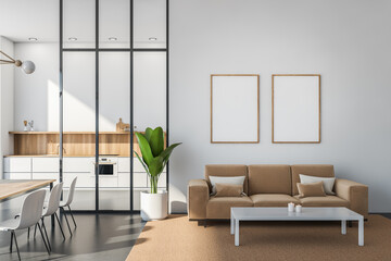 Two posters in white and beige space with seating area and kitchen