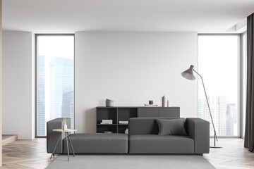 Living room interior with white wall, comfortable large grey couch