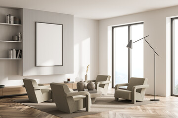 Living room with armchairs and wall panelling in mild shades. Corner view