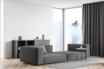 Corner view of living room interior with large grey sofa