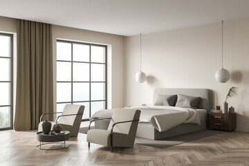 Bright bedroom interior with large bed and two comfortable armchair