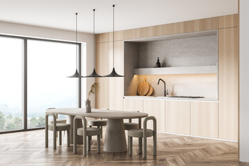 Corner of minimalist panoramic kitchen with beige furniture and three lights
