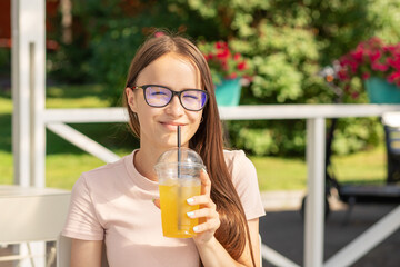 happy teenager girl with cool summer drink in sea cafe on beach party in sunny day