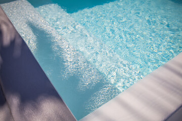 Abstract swimming pool background. Summer relax and recreational concept, blue ripped water with...