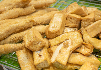 Chinese tofu fried in soybean oil on banana leaves. Traditional chinese food.