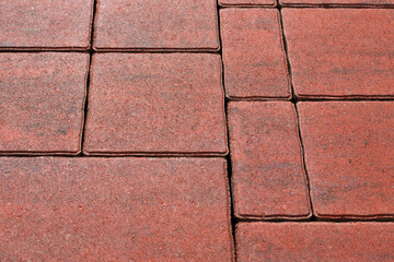 Spreading paving with sidewalk slabs of different sizes. Selective focus on the center of the composition.