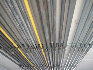Obraz premium Metallic iron pipe row engine structure silver steel line cable equipment manufacturing technician energy power station control voltage system factory company business network industry concept