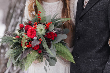 bright bouquet with red flowers bouquet for winter wedding. High quality photo