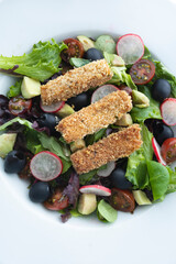 Green leafy salad, tomato, avocado, radishes, olives and tofu fingers. Vegetarian salad. Vegan food photography