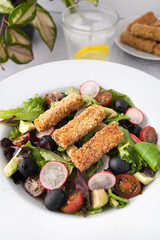 Green leafy salad, tomato, avocado, radishes, olives and tofu fingers. Vegetarian salad. Vegan food photography