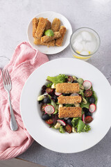 Green leafy salad, tomato, avocado, radishes, olives and tofu fingers. Vegetarian salad. Vegan food photography