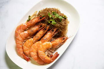Shrimp potted with vermicelli; dipping black vinegar sauce or spicy seafood sauce. Main Ingredient is glass noodle, coriander roots, pepper, garlic, ginger and shrimp.
