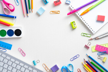 Flat lay colorful school supplies on white background. Back to school concept. Top view, overhead.