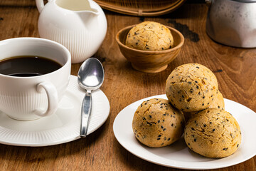 Closeup view pile of sesame mochi bun in white ceramic plate.