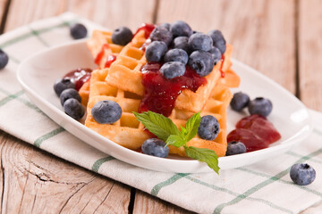 Waffles with blueberries and jam. 