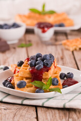 Waffles with blueberries and jam. 