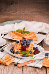 Waffles with blueberries and jam. 