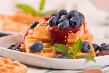 Waffles with blueberries and jam. 