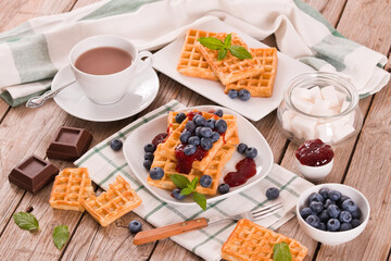 Waffles with blueberries and jam. 