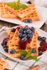 Waffles with blueberries and jam. 