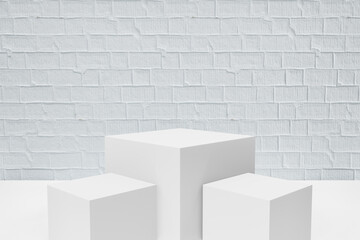 Display product stand, Three white block box podium on white paint bricks background. 3D rendering illustration