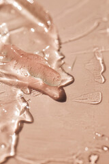 Liquid gel or serum drops  on pink background in macro.