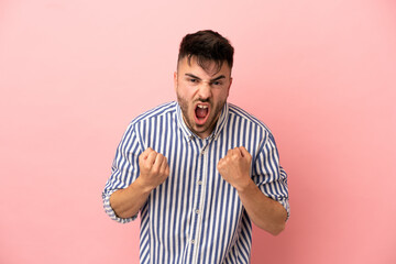 Young caucasian man isolated on pink background frustrated by a bad situation