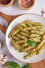 Pasta spaghetti with zucchini, basil, cream and cheese on black stone table. vegetarian vegetable pasta. zucchini noodles. top view copy space. penne pasta with pesto sauce, flat lay.