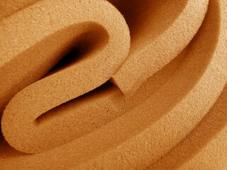 folds or rolls of a complex orange color sponge foam material