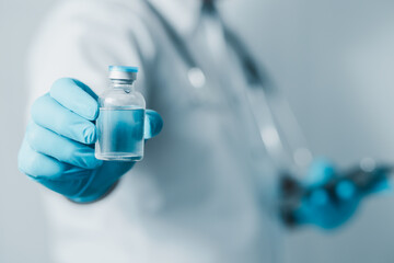 Doctor or scientist in sanitary uniform showing coronavirus vaccine, healthcare and medical concept.
