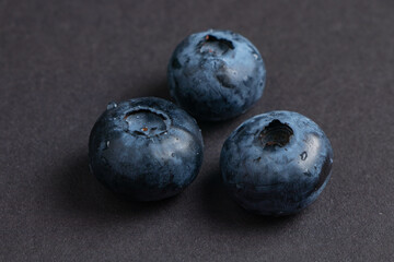 Blueberries fruit background. Water drops on ripe sweet blueberry. Collection of blue and black berries. Conceptual food image..