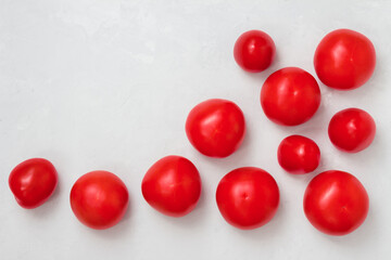 Tomatoes scattered on a concrete gray background , top view, copie space