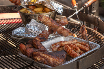 Barbecue fried sausages background, close-up. Sausage kebab on coals. Traditional cooking. Family picnic in the open air. Selective focus. Meat Blends
