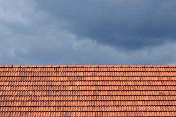 Roof tile pattern over blue sky