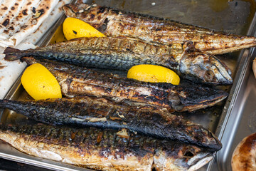 Grilled mackerel fish in a pan with vegetables