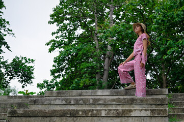 Young women with a dignified look standing and looking at the sky , surrounded by green forest area in countryside of chiang mai thailand , freedom , hope and dream concept