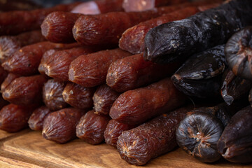 Handmade smoked sausages on food market.