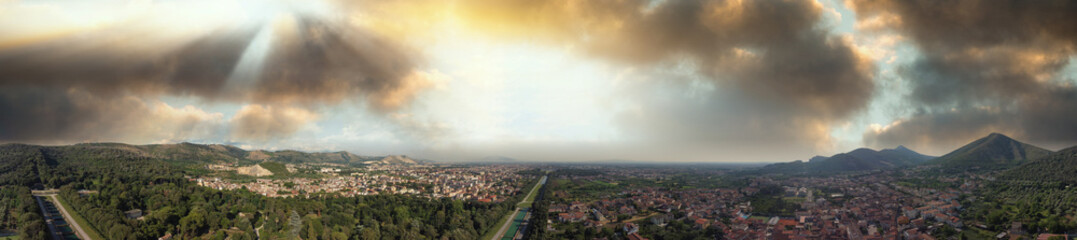 Famous royal palace of Caserta at sunset, panoramic aerial view from a drone viewpoint.