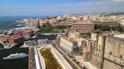 Fototapeta premium Naples, Italy. Aerial view of city port from a drone going up in the sky.