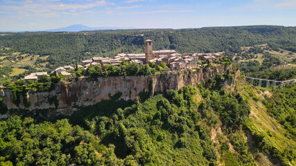 Panoramic aerial view of Civita di Bagnoregio from a flying drone around the medieval city, Italy.